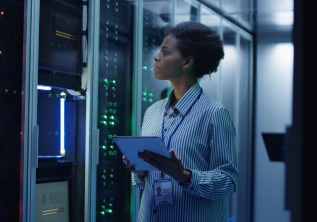 Technician reviewing server array